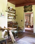 Plate rack, wooden table and antique picture in vintage kitchen