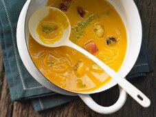 Pumpkin and carrot soup with baked apple and cheddar cheese
