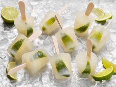 Tequila and lime ice lollies on a bed of ice cubes