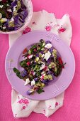 A salad with beetroot leaves, purple cauliflower and feta