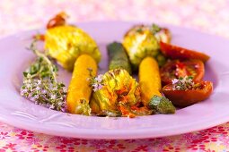 Courgette flowers, tomatoes and thyme as a side dish