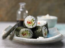 Maki sushi with cucumber, avocado, lettuce and peppers
