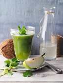 Pear and cucumber smoothie with coconut water and fresh herbs