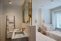 Large brass mirror above ensuite washstand in twin bedroom