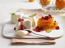 White chocolate and yoghurt mousse with oranges and pomegranate seeds