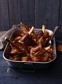 Braised lamb shanks in a roasting tray