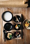 Breakfast with rice porridge, side dishes and tea (Japan)