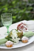 Rolled place mat with napkin ring made from flowers