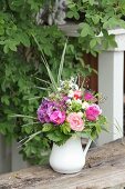 Luxuriant summer bouquet of pink flowers in jug