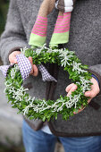 Wreath of box and santolina held in hands