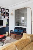 Seating and fitted shelves in corner of lounge with interior window