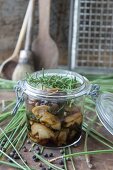 Preserved mushrooms with rosemary in a glass jar