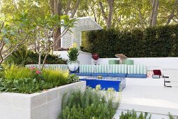 Terraced garden with padded lounge area and plant beds