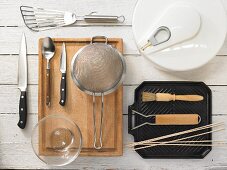 Kitchen utensils for preparing club sandwiches with grilled vegetables and pesto cream