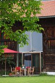 Modernised barn with tall window and terrace