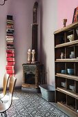 Old wood-burner in corner next to vertical bookshelf