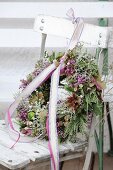 Autumn wreath with ribbon and lace trim on old chair