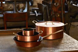 Copper pots with coating at the Kupfermanufaktur Weyersberg copper factory in Baden-Württemberg, Germany