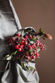 Bouquet of rose hips in vintage knapsack