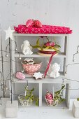 Shelves festively decorated with angels. biscuits, glass ornaments and mistletoe
