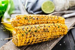 Delicious grilled corn on a wooden board