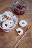 Spitzbuben (jam cookies) with a doiley in a small bowl