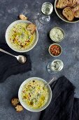 Charred Broccoli Cheddar Potato Soup drizzeled with Olive Oil and sprinkled with red chili flakes with Crostini