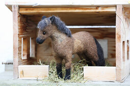 Hand-made, felted, woollen horse in miniature stable