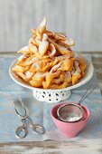 Faworki (Polish fried pastries) with icing sugar