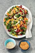 Kale salad with chicory, yellow pepper, carrot and peanut butter dressing