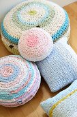 Various pastel cushions with crocheted covers made from T-shirt yarn