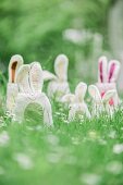 Whimsical felt bunnies hidden amongst grass