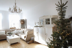 Christmas tree and old dresser in cream living room