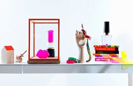 Still-life arrangement of neon accessories and books