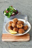 Sprat and potato cakes with black olives