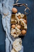 Eggs and crumpled paper in vintage cardboard box