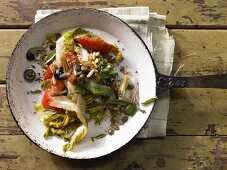 Braised romaine lettuce salad with tomatoes, olives and parmesan