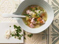 Potato and vegetable soup with smoked pork and horseradish