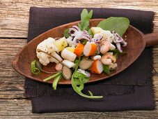 Lukewarm seafood salad with vegetables and giant capers