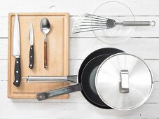 Various kitchen utensils: pans, spatula, knives, spoons