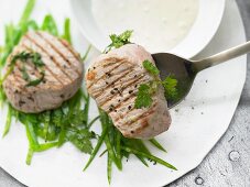 Steamed veal fillet steaks with sugar snaps and chervil