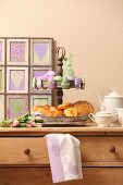 Pastries on vintage cake stand and Easter ornaments on top of chest of drawers