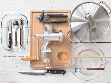 Various kitchen utensils: mincer, can opener, pot, knife, spoon
