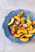 Nectarine slices and figs with sugar on a plate