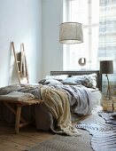 Sand-coloured textiles and driftwood accessories in bedroom