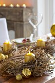 Festive table decorated with dried wreaths and gold candles