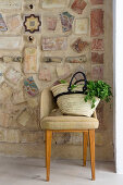 Shopping bag on chair in front of Mediterranean mosaic wall