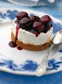 Individual gluten free cherry cheesecake on an antique plate