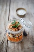 Couscous salad with chicken in a glass jar with lid