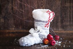 A Christmas boot with apples and candy canes